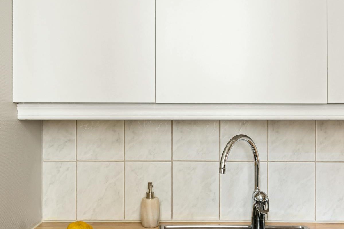 Kitchen renovation Geelong project showing new white cabinetry, a tiled splashback and timber benchtop